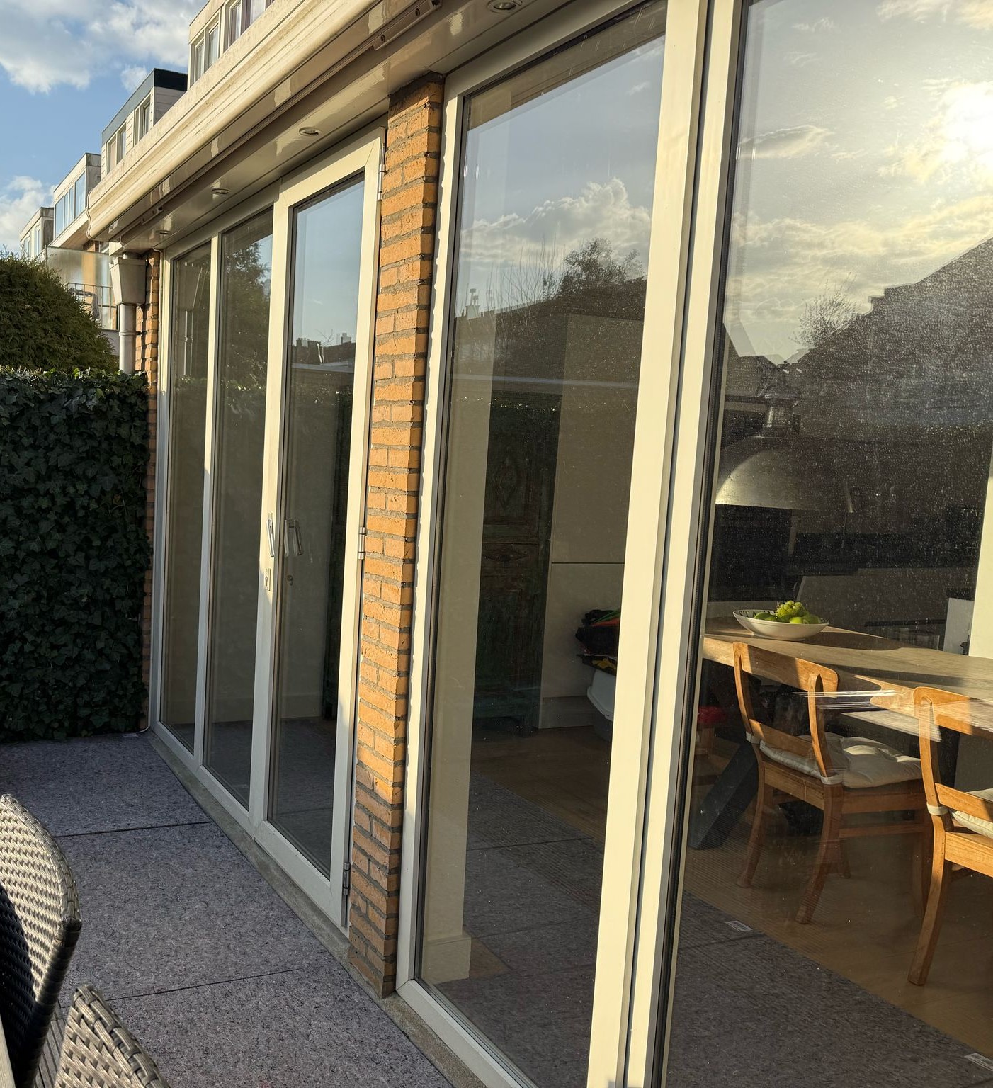 Achterzijde van woning met schuifpui waarbij isolatieglas is gezet