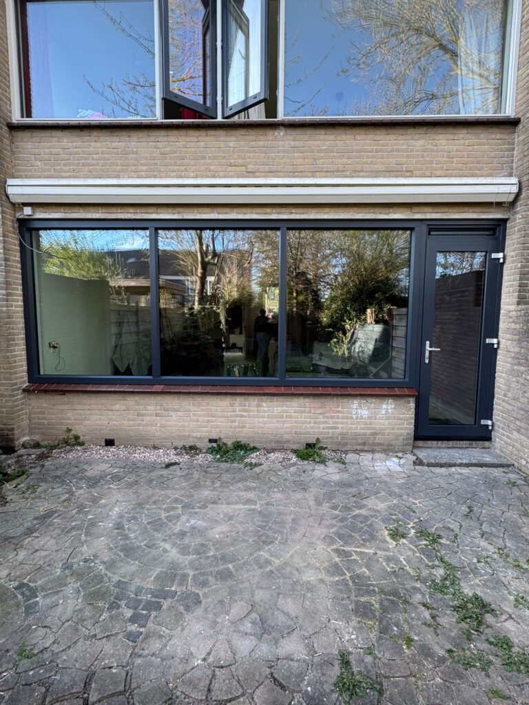 Nieuwe antraciet kunststof achterpui met vaste ramen en geïntegreerde tuindeur
